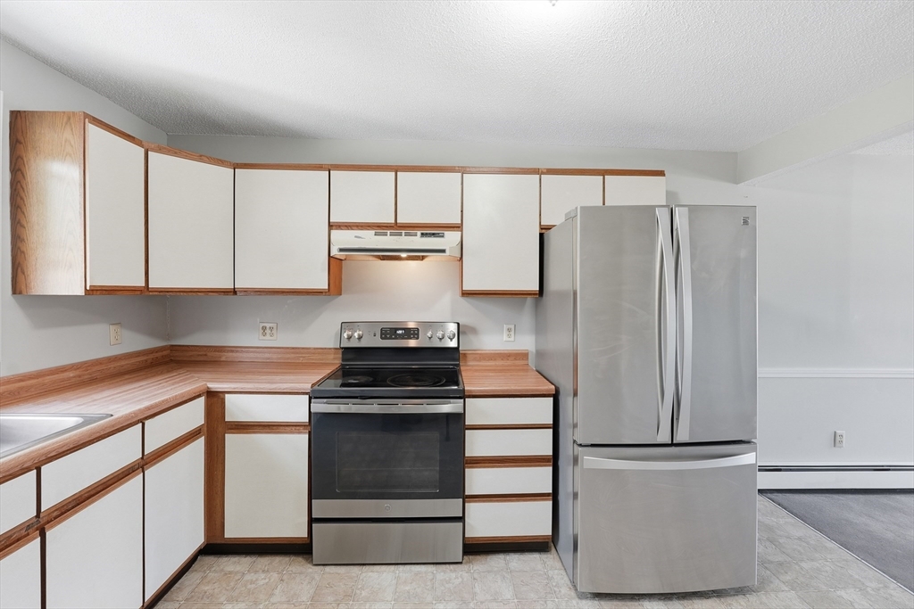 146 Hecla Street, Unit 2 Uxbridge, MA 01569 - Photo 12 of 26 a kitchen with appliances and cabinets