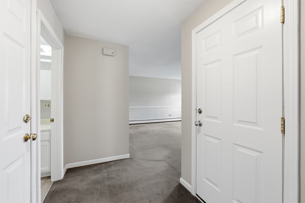 146 Hecla Street, Unit 2 Uxbridge, MA 01569 - Photo 14 of 26 a bathroom with a glass shower door