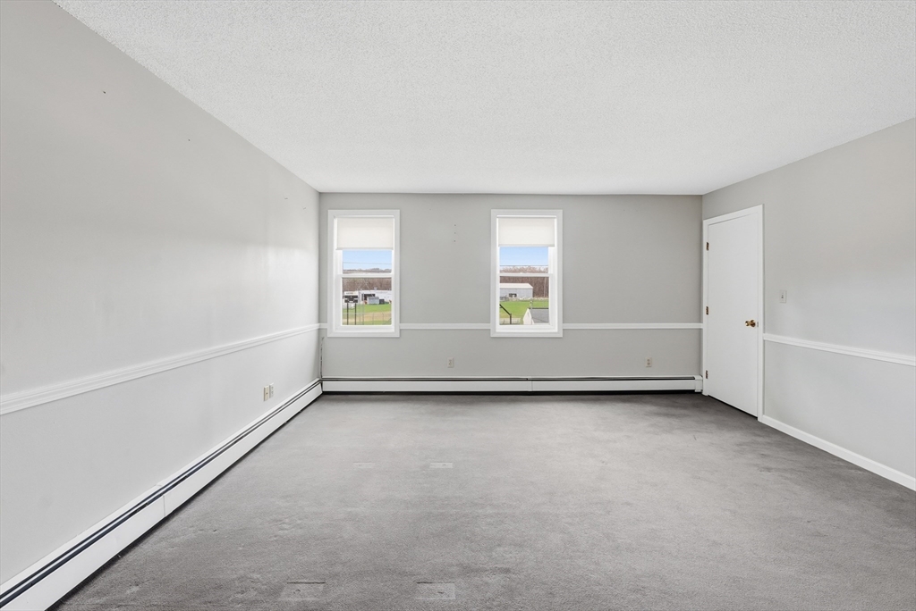 146 Hecla Street, Unit 2 Uxbridge, MA 01569 - Photo 15 of 26 an empty room with windows