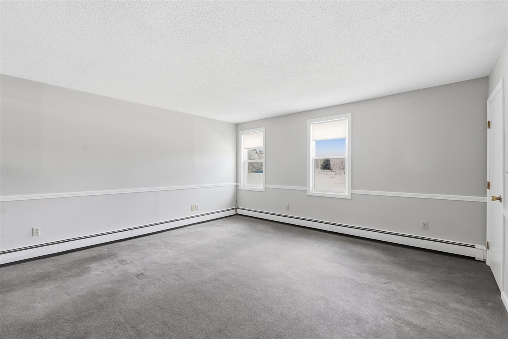 146 Hecla Street, Unit 2 Uxbridge, MA 01569 - Photo 16 of 26 an empty room with a empty space and window