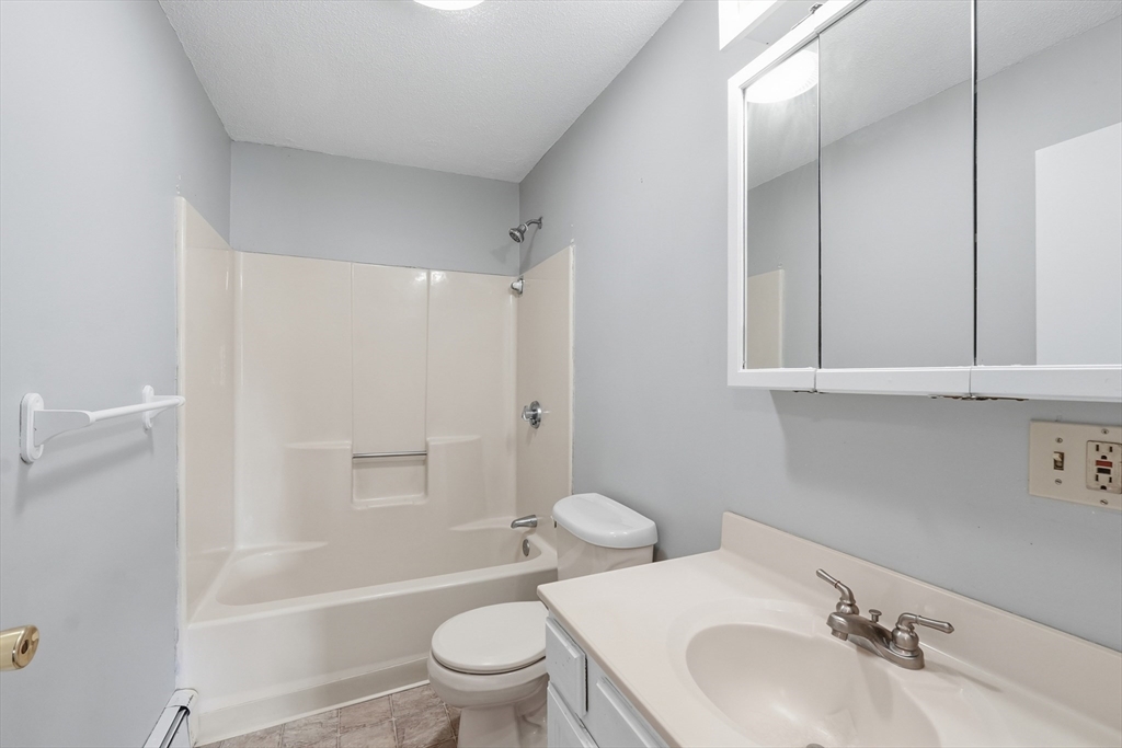 146 Hecla Street, Unit 2 Uxbridge, MA 01569 - Photo 19 of 26 a bathroom with a sink toilet and shower
