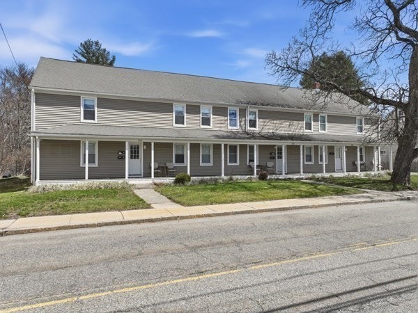 146 Hecla Street, Unit 2 Uxbridge, MA 01569 - Photo 2 of 26 front view of a brick house with a yard