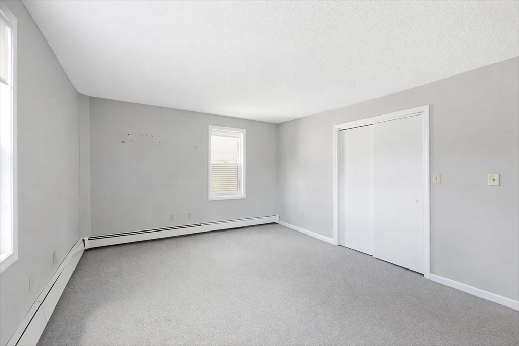 146 Hecla Street, Unit 2 Uxbridge, MA 01569 - Photo 21 of 26 an empty room with windows