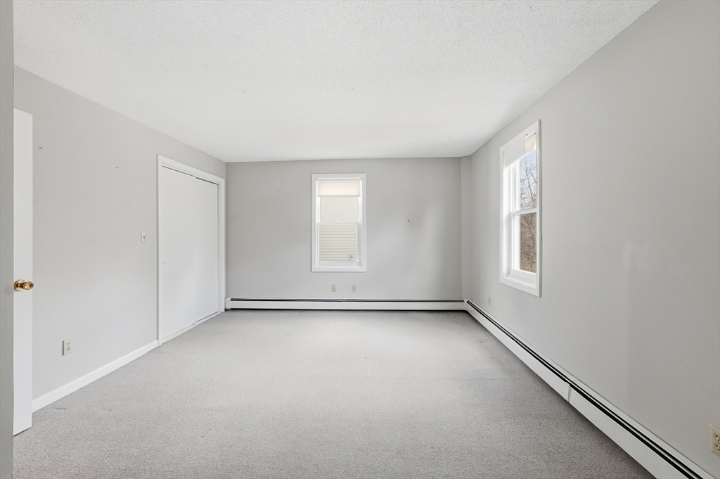 146 Hecla Street, Unit 2 Uxbridge, MA 01569 - Photo 22 of 26 an empty room with windows