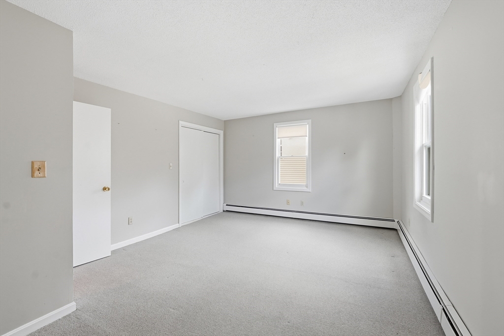 146 Hecla Street, Unit 2 Uxbridge, MA 01569 - Photo 23 of 26 an empty room with windows