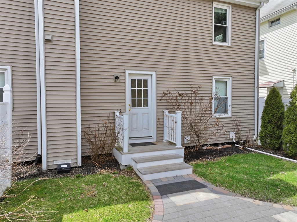 146 Hecla Street, Unit 2 Uxbridge, MA 01569 - Photo 6 of 26 a front view of a house with a yard