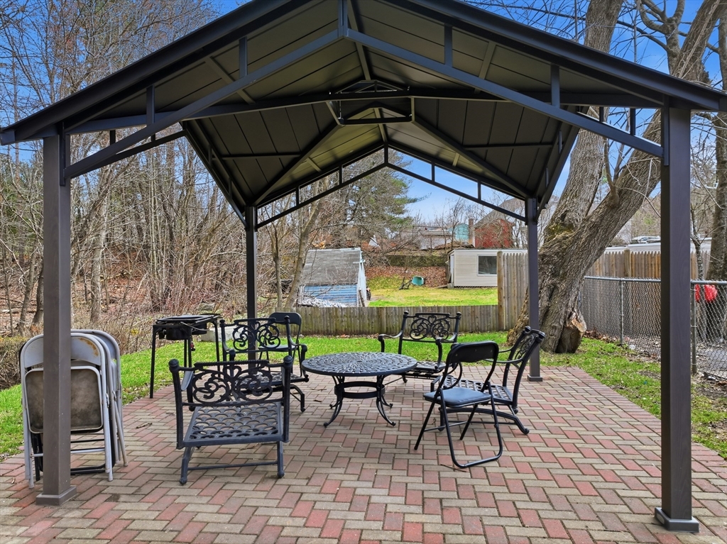 146 Hecla Street, Unit 2 Uxbridge, MA 01569 - Photo 9 of 26 a view of a chairs and table in the patio