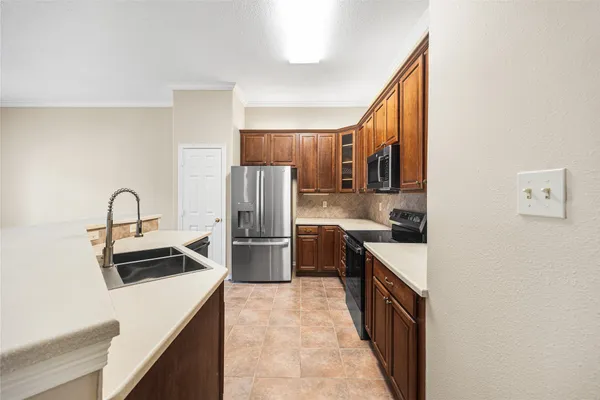 a kitchen with stainless steel appliances granite countertop a refrigerator and a sink
