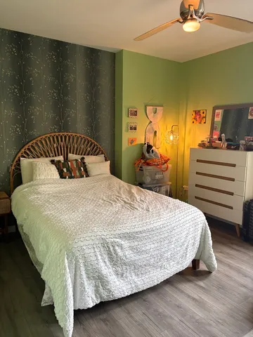 a bedroom with a bed and a chandelier