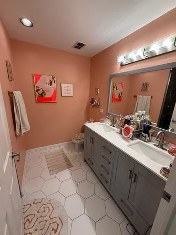 a bathroom with a sink mirror and vanity