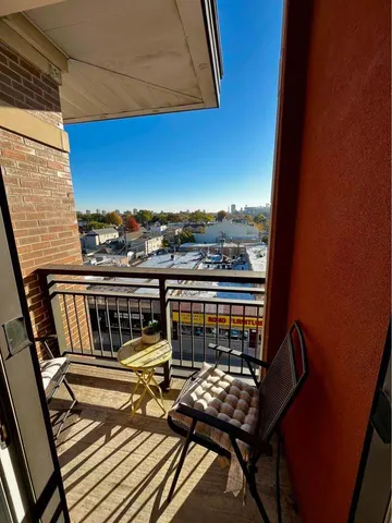 a view of a balcony with wooden floor