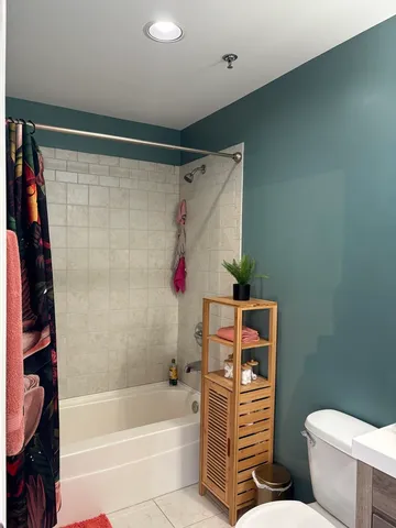 a bathroom with a toilet and a shower