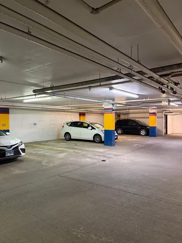 a view of parking garage with cars