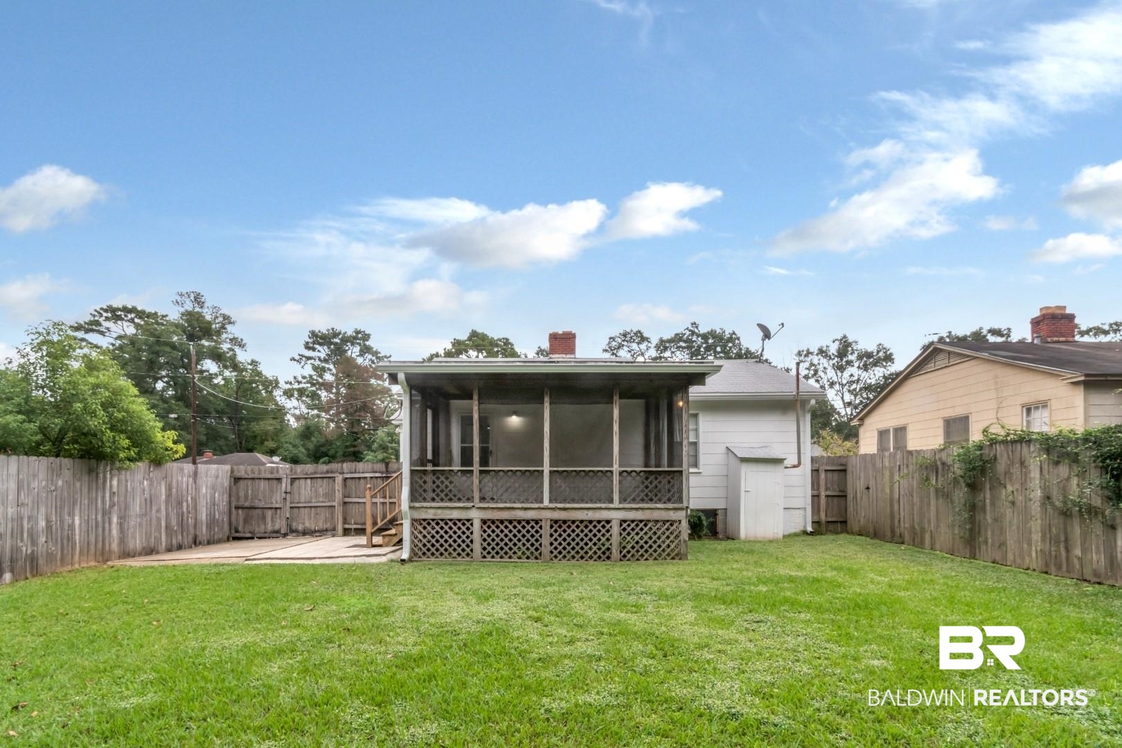 208 Morgan Avenue Mobile, AL 36606 - Photo 21 of 27 Rear view of house featuring a sunroom, a yard, and a patio