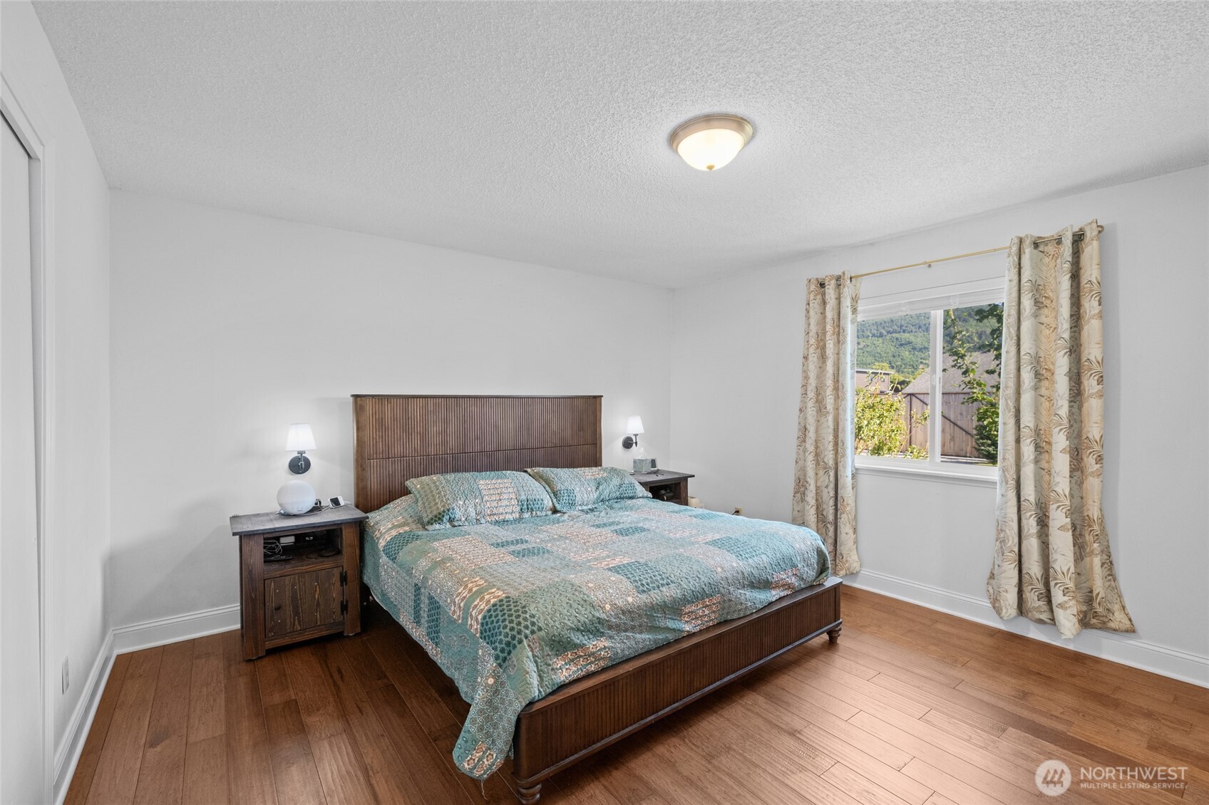 415 Sterling Street Sedro-Woolley, WA 98284 - Photo 23 of 38 a bedroom with a bed and wooden floor