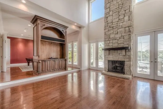 a view of a livingroom with wooden floor a fireplace