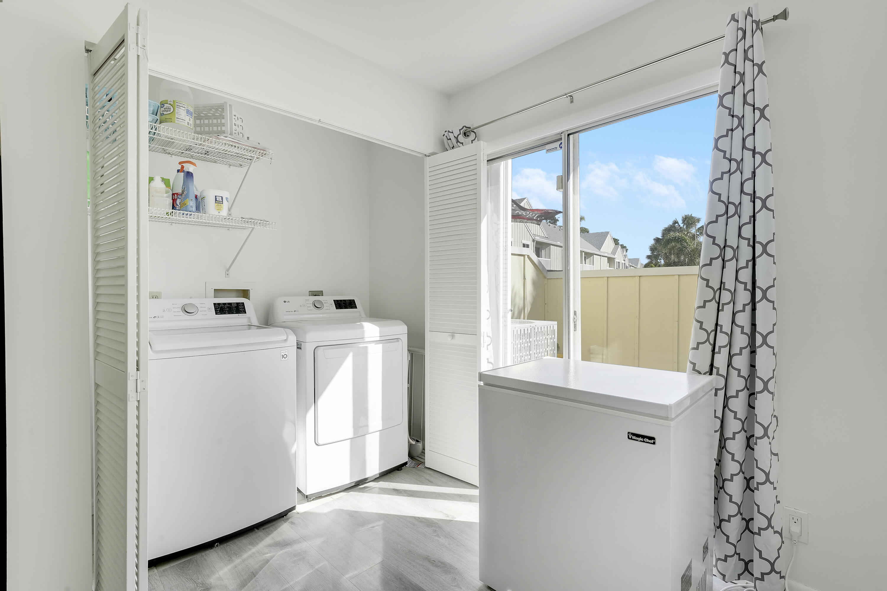 6263 Riverwalk Lane, Unit 2 Jupiter, FL 33458 - Photo 17 of 44 a bathroom with a sink mirror and window