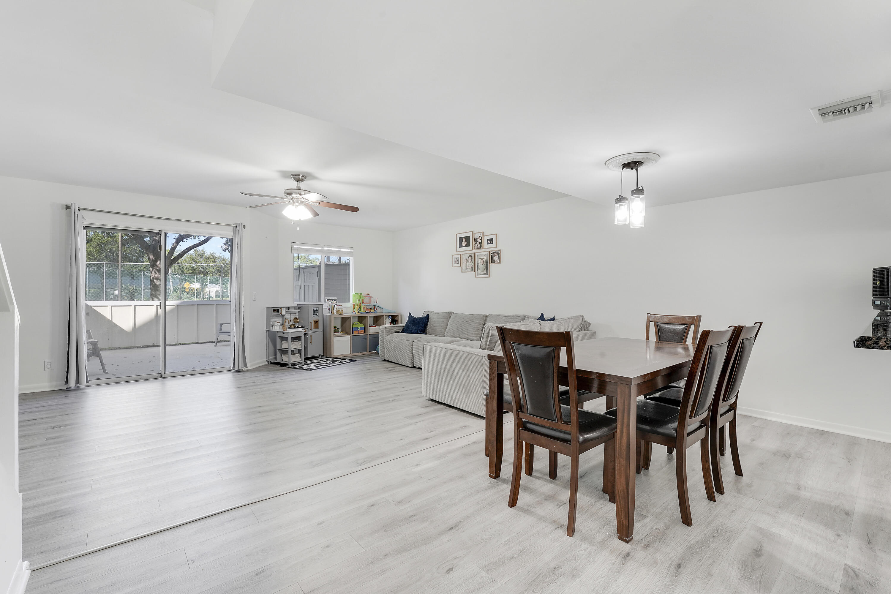 6263 Riverwalk Lane, Unit 2 Jupiter, FL 33458 - Photo 18 of 44 a view of a dining room with furniture and chandelier