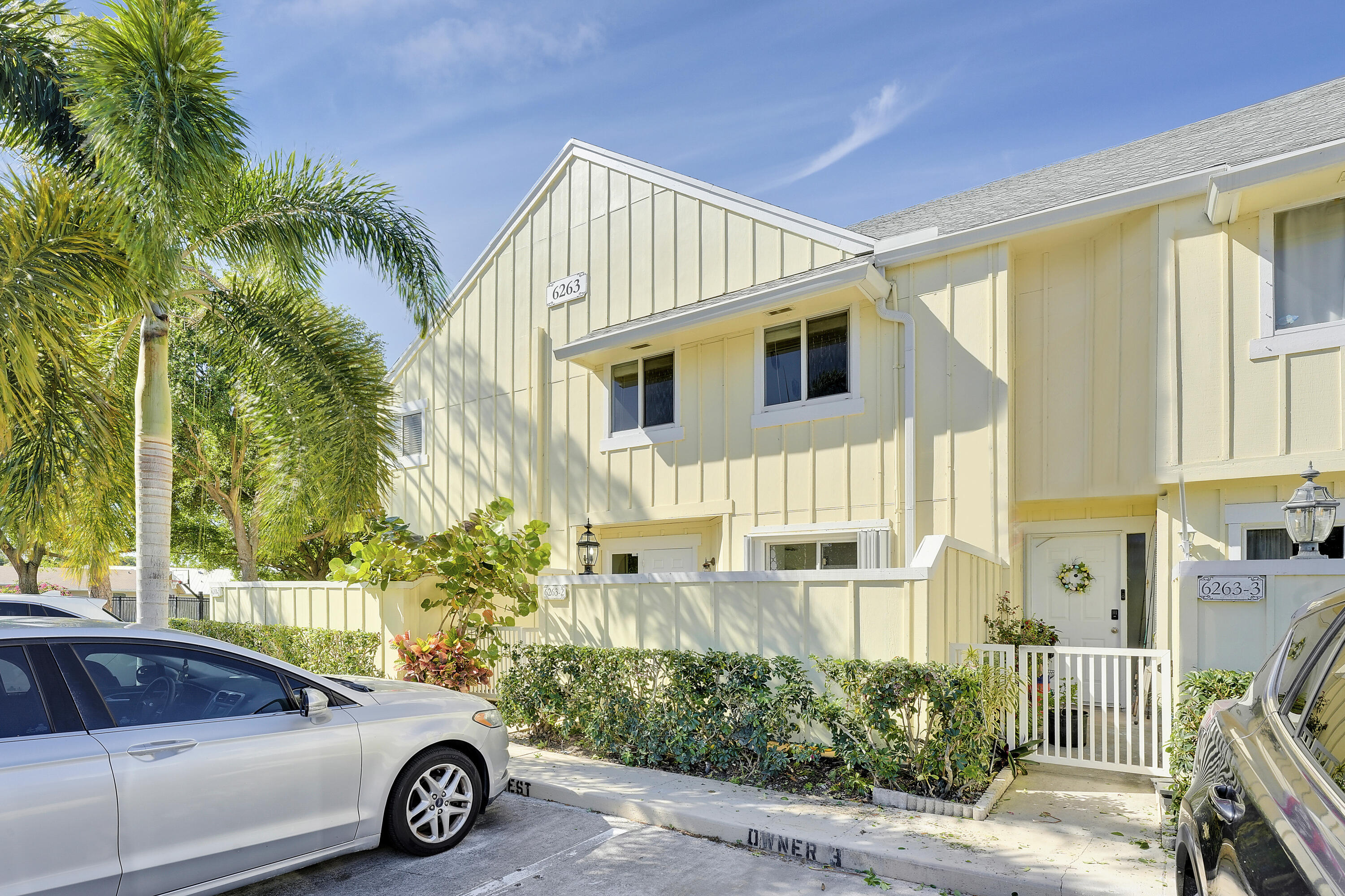 6263 Riverwalk Lane, Unit 2 Jupiter, FL 33458 - Photo 2 of 44 a view of a car parked in front of a house