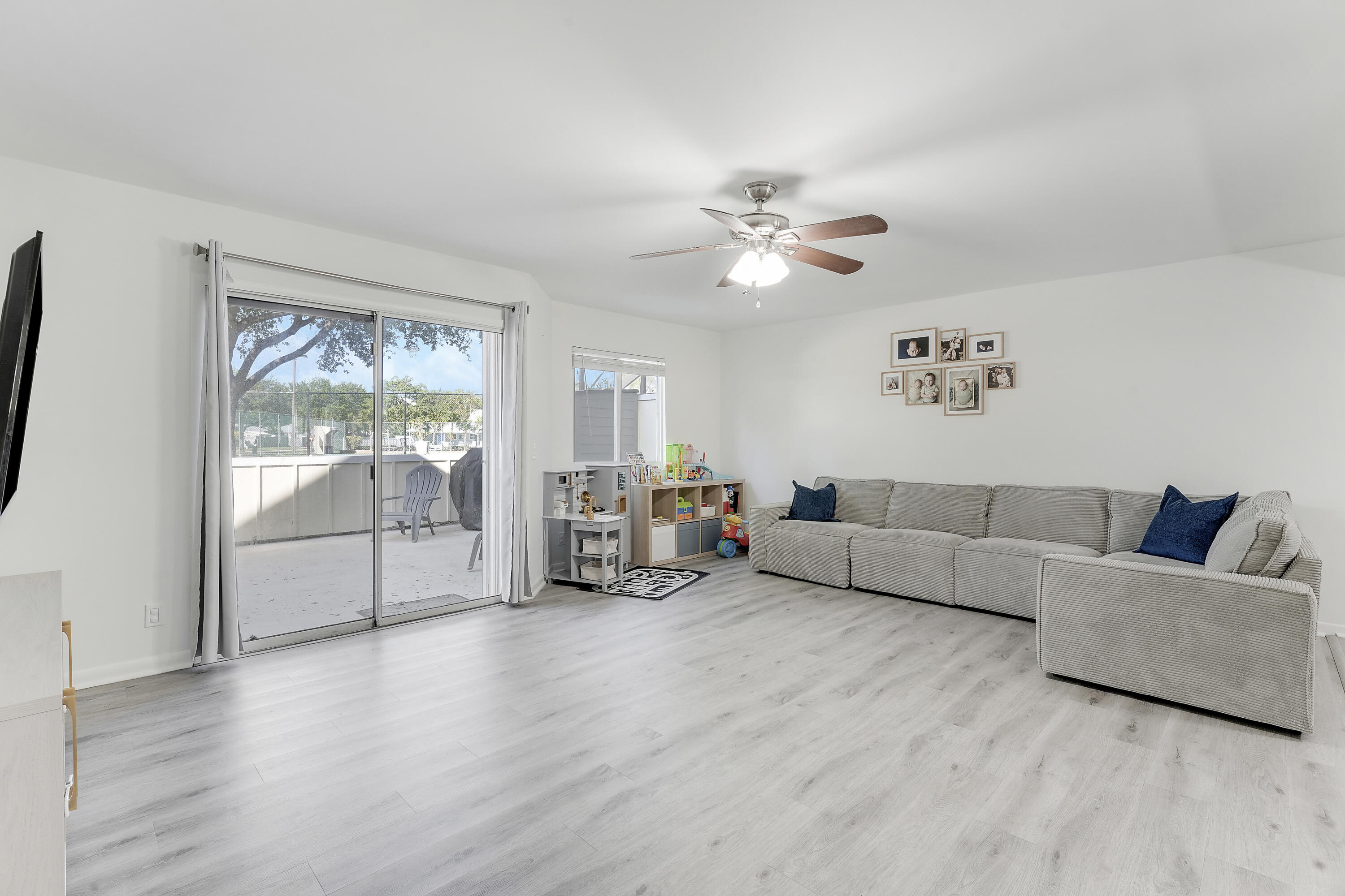 6263 Riverwalk Lane, Unit 2 Jupiter, FL 33458 - Photo 21 of 44 a living room with furniture and a large window