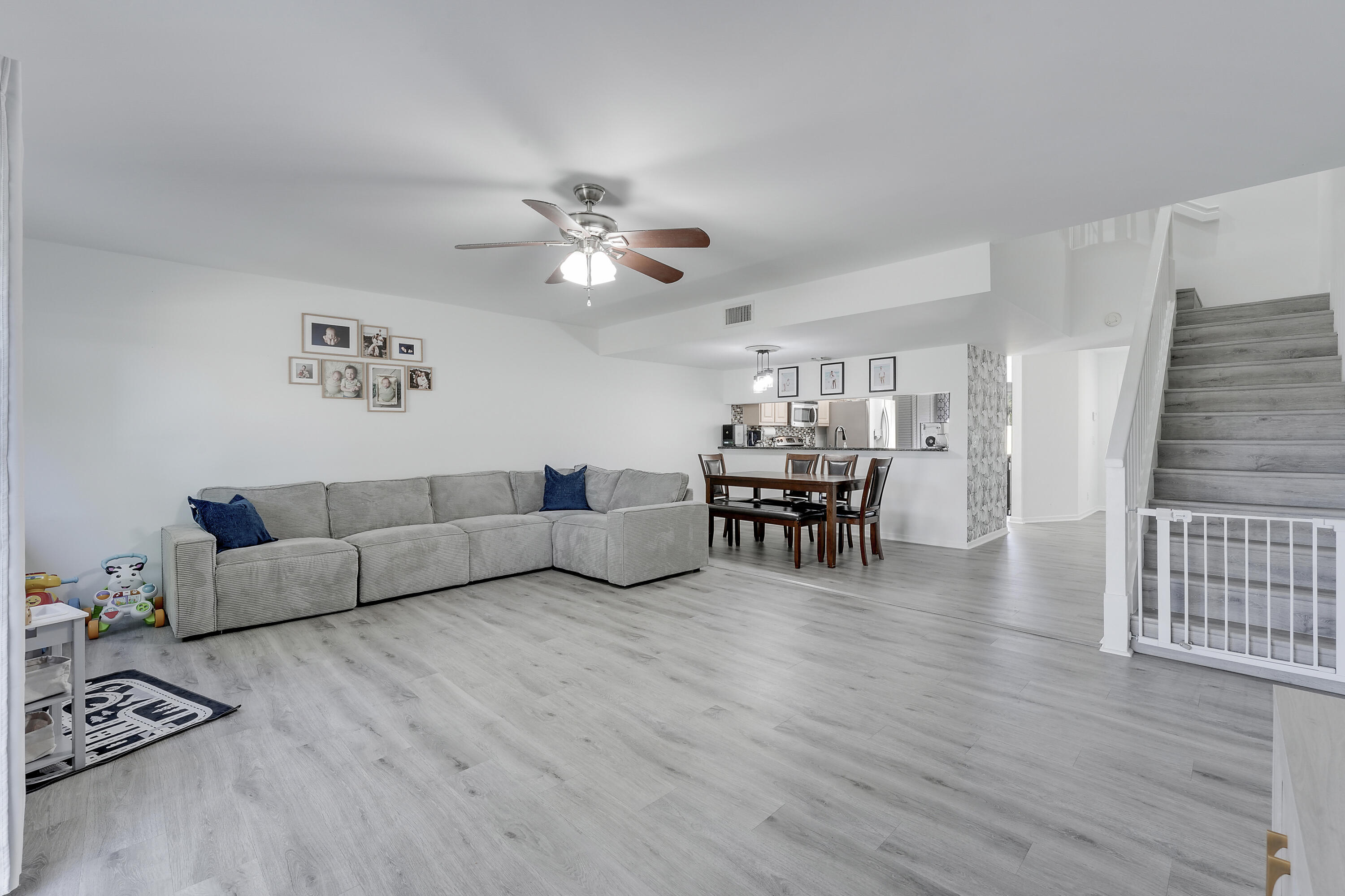 6263 Riverwalk Lane, Unit 2 Jupiter, FL 33458 - Photo 23 of 44 a living room with furniture and wooden floor