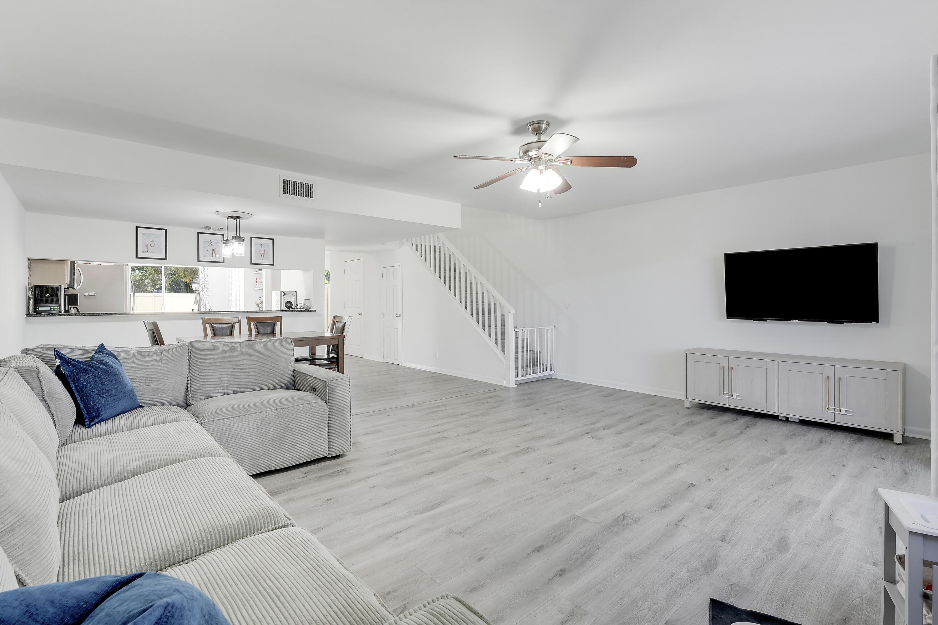 6263 Riverwalk Lane, Unit 2 Jupiter, FL 33458 - Photo 24 of 44 a living room with furniture and a flat screen tv
