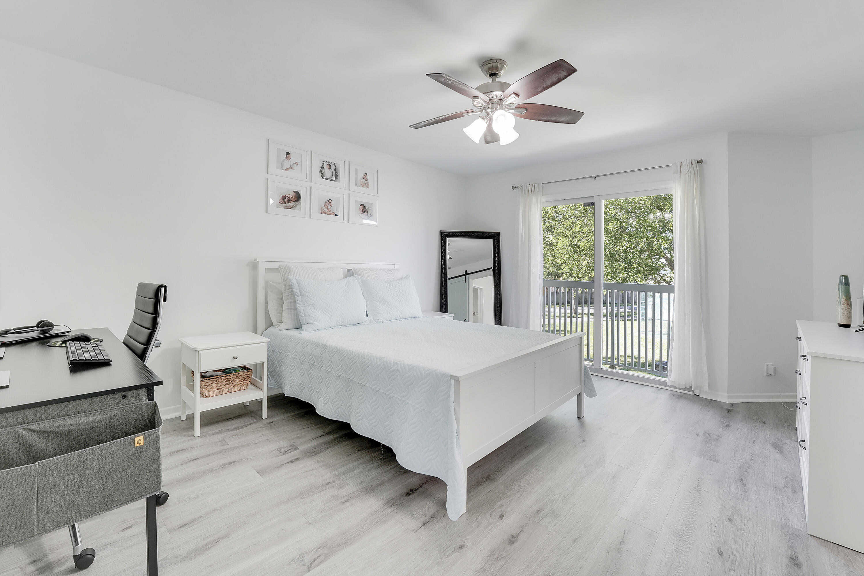 6263 Riverwalk Lane, Unit 2 Jupiter, FL 33458 - Photo 25 of 44 a bedroom with a bed and a chandelier