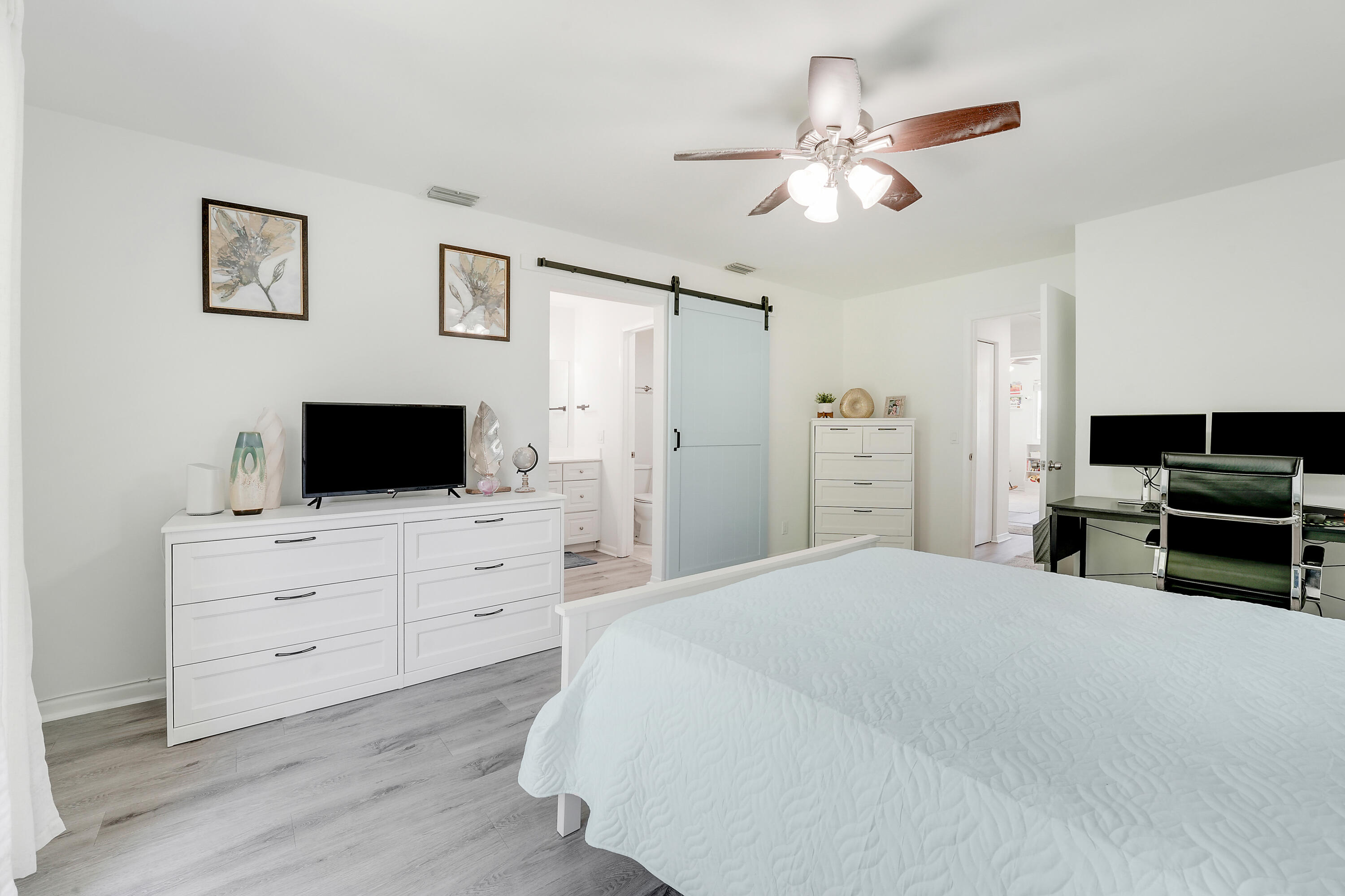 6263 Riverwalk Lane, Unit 2 Jupiter, FL 33458 - Photo 26 of 44 a bedroom with a bed and a television