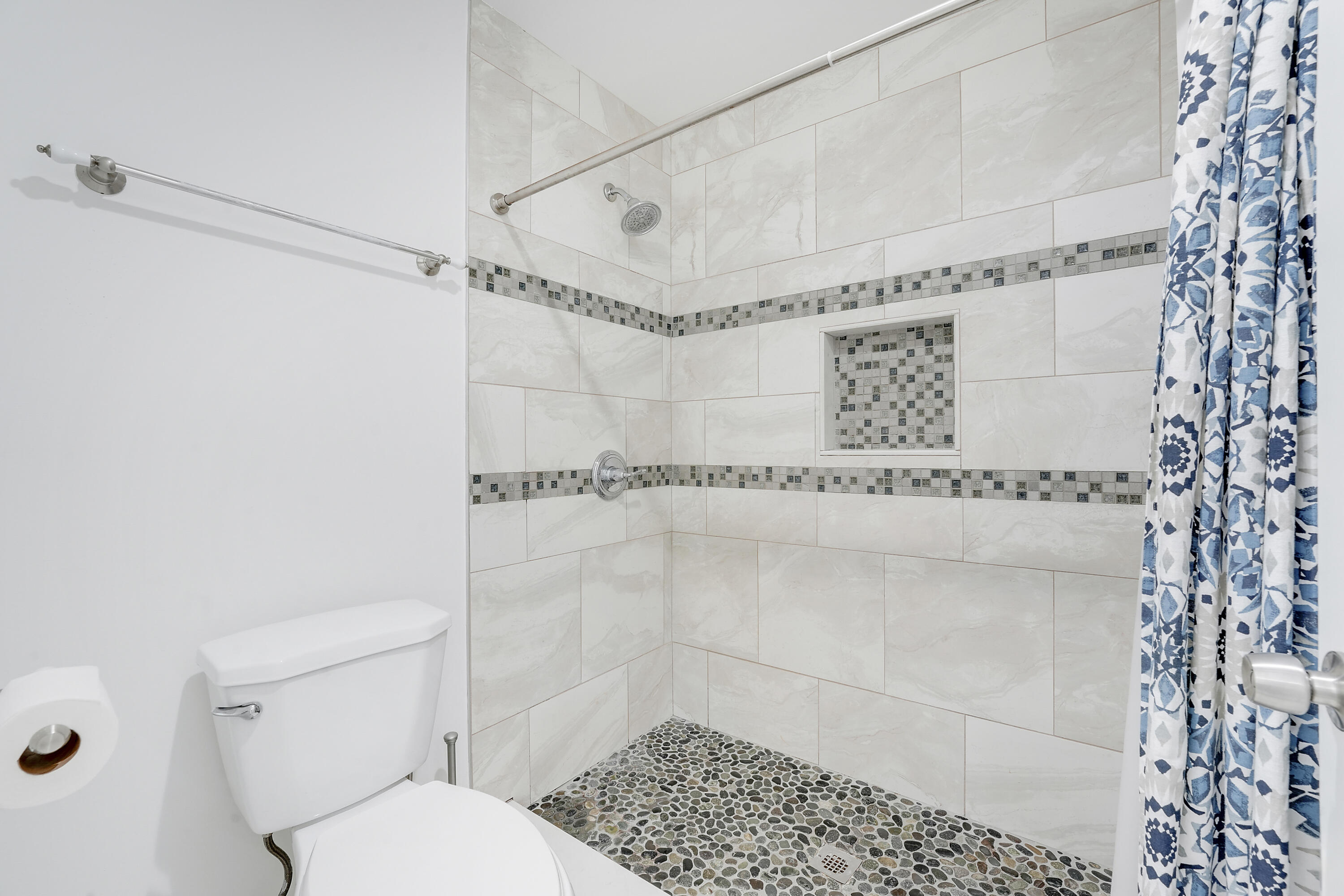 6263 Riverwalk Lane, Unit 2 Jupiter, FL 33458 - Photo 28 of 44 a bathroom with a shower a toilet and a shower