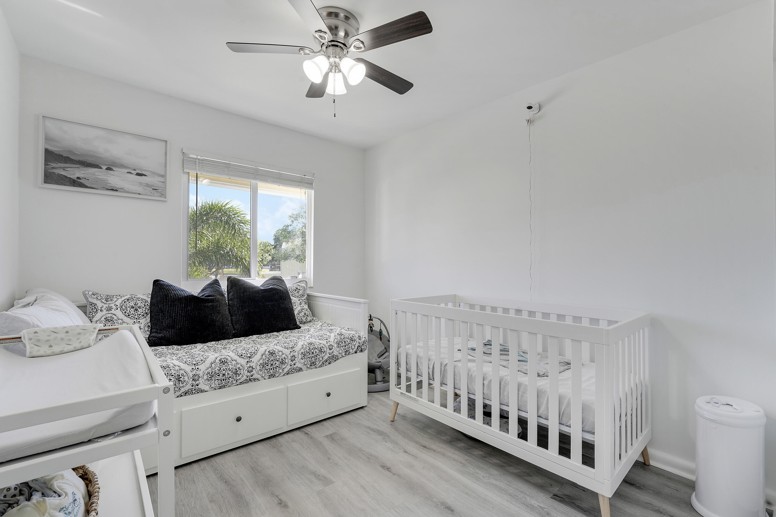 6263 Riverwalk Lane, Unit 2 Jupiter, FL 33458 - Photo 31 of 44 a bedroom with a bed and a window