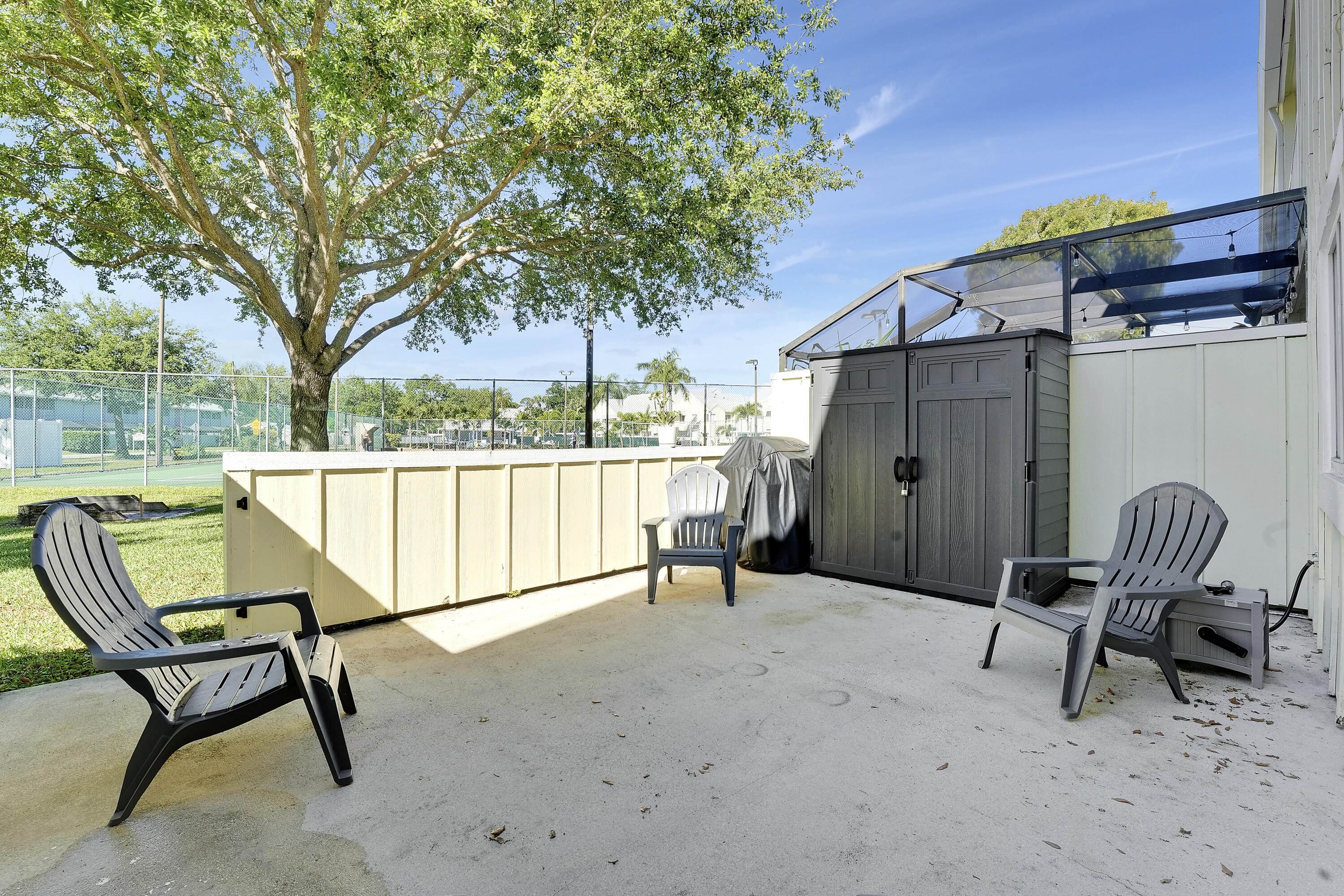 6263 Riverwalk Lane, Unit 2 Jupiter, FL 33458 - Photo 35 of 44 a view of a chairs in a patio
