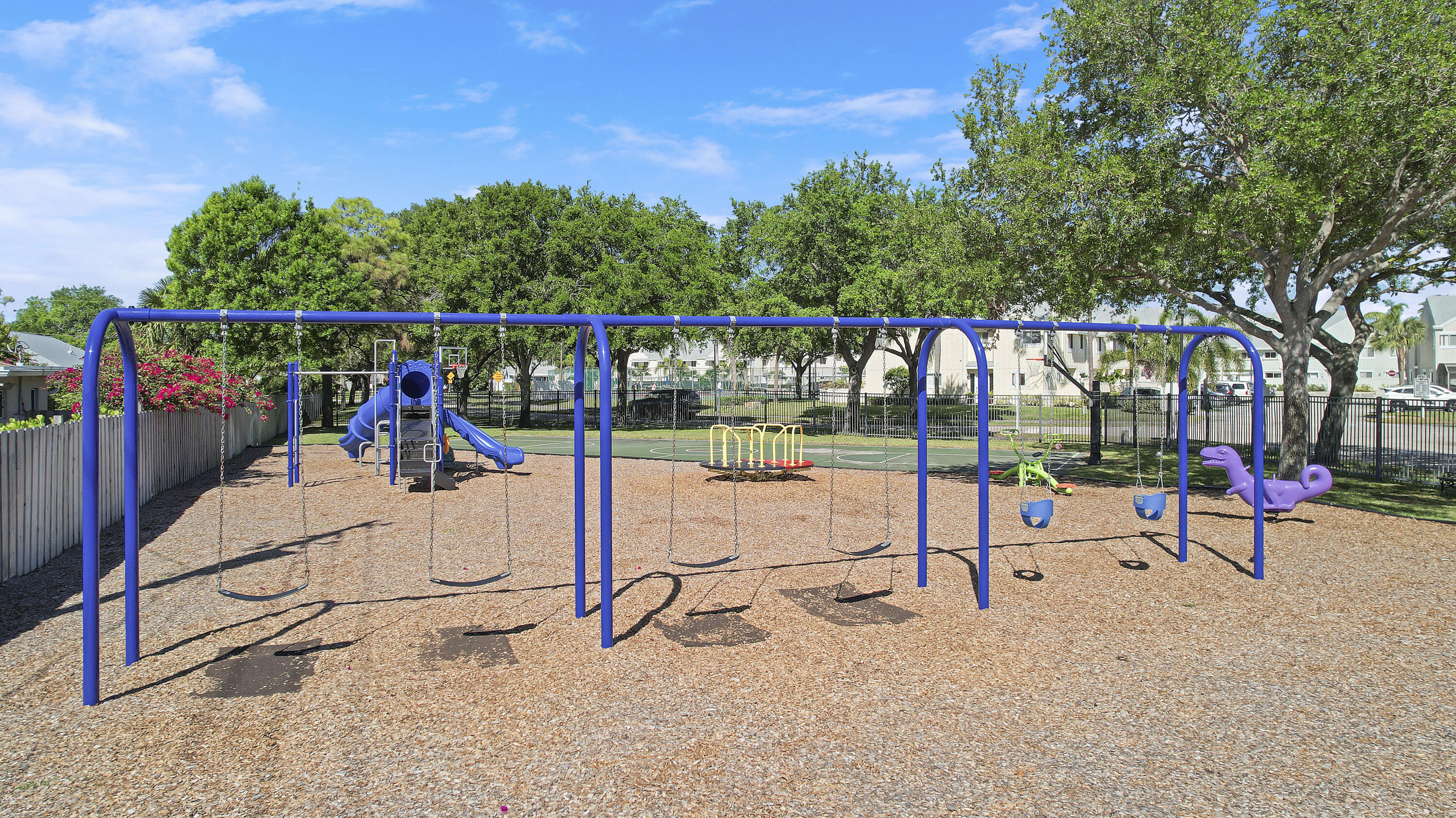6263 Riverwalk Lane, Unit 2 Jupiter, FL 33458 - Photo 42 of 44 a view of a park with swings and slides