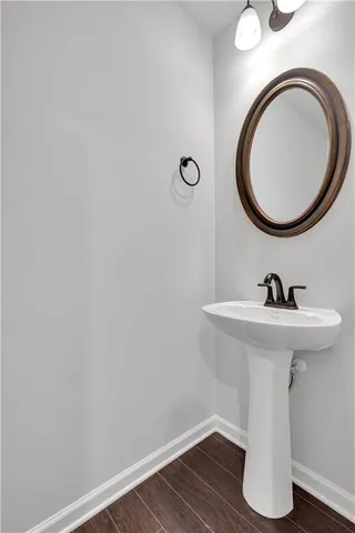 a white toilet sitting next to a white wall