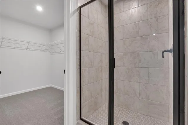 a white toilet sitting next to a white wall