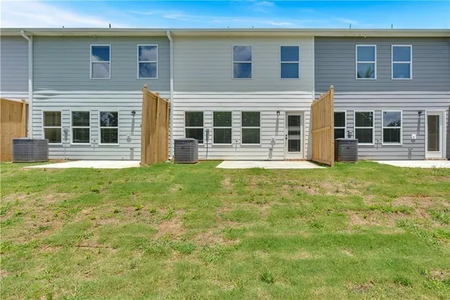 a front view of a house with a yard and outdoor seating