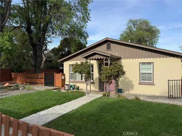 a front view of house with a garden and patio