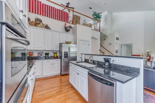 a kitchen with stainless steel appliances granite countertop a sink and cabinets
