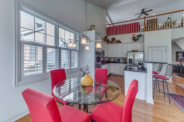 a dining room with furniture a rug and wooden floor