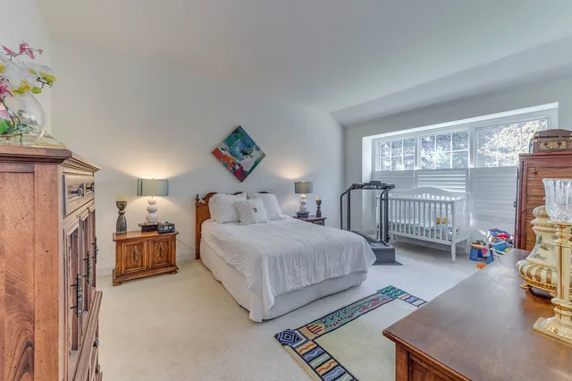 a bedroom with a bed couch and a window