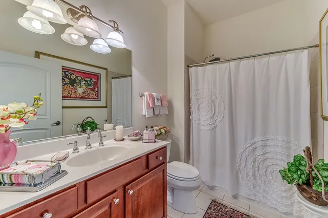 a bathroom with a sink a large mirror and a toilet