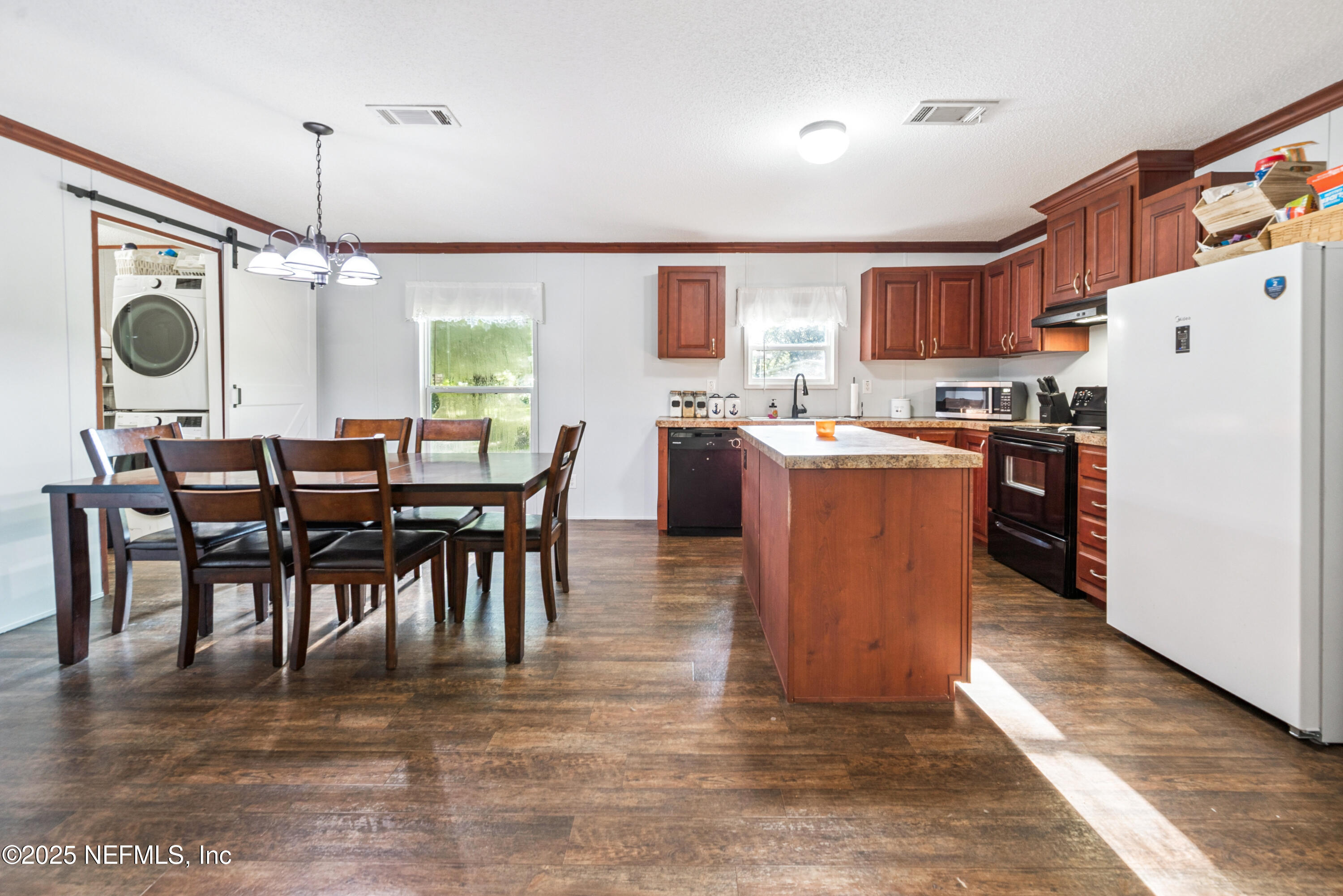 7236 Southeast 163rd Lane Lake Butler, FL 32054 - Photo 12 of 35 a dining room with stainless steel appliances granite countertop a dining table chairs and a refrigerator