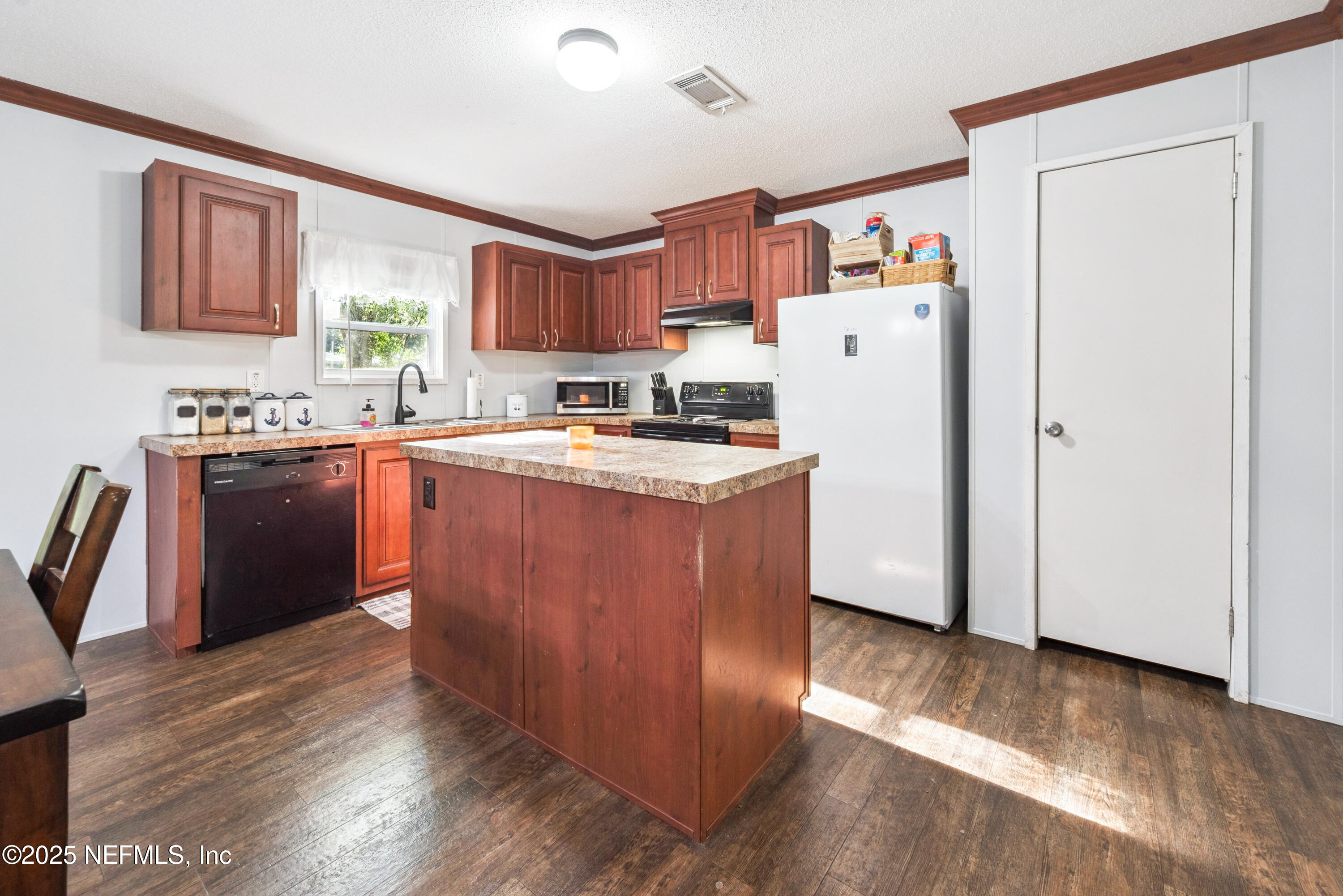 7236 Southeast 163rd Lane Lake Butler, FL 32054 - Photo 13 of 35 a kitchen with wooden cabinets and wooden floor
