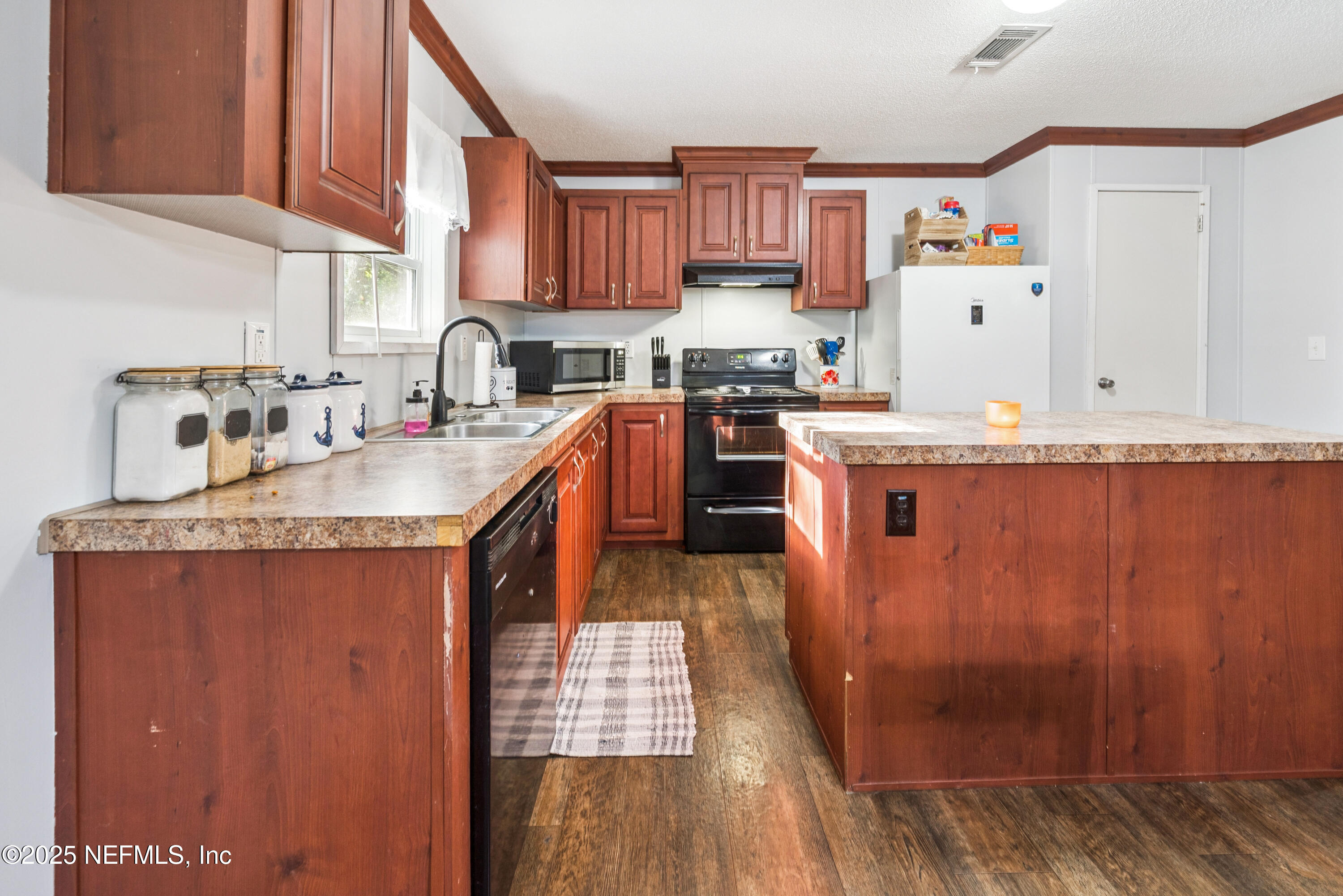 7236 Southeast 163rd Lane Lake Butler, FL 32054 - Photo 14 of 35 a kitchen with granite countertop a sink stove and cabinets