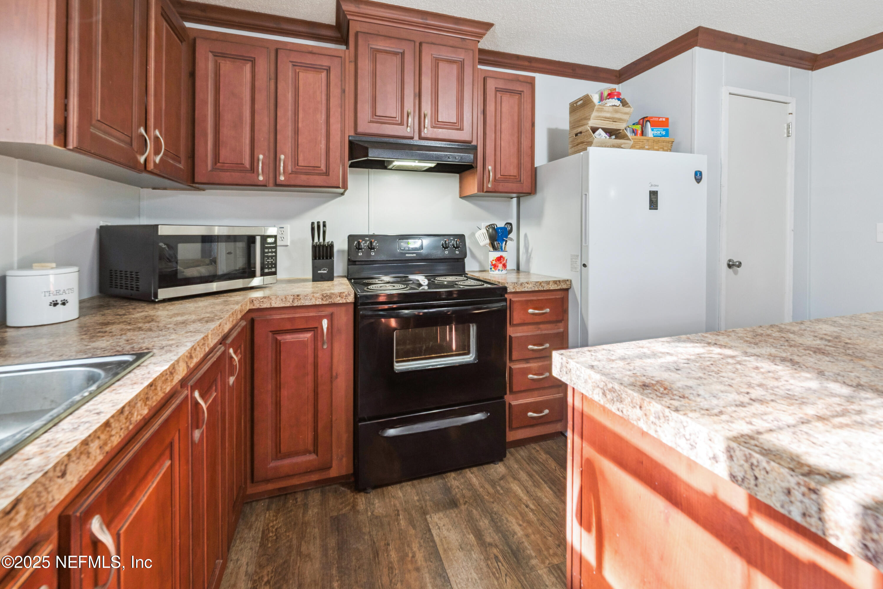 7236 Southeast 163rd Lane Lake Butler, FL 32054 - Photo 15 of 35 a kitchen with granite countertop a refrigerator stove and sink