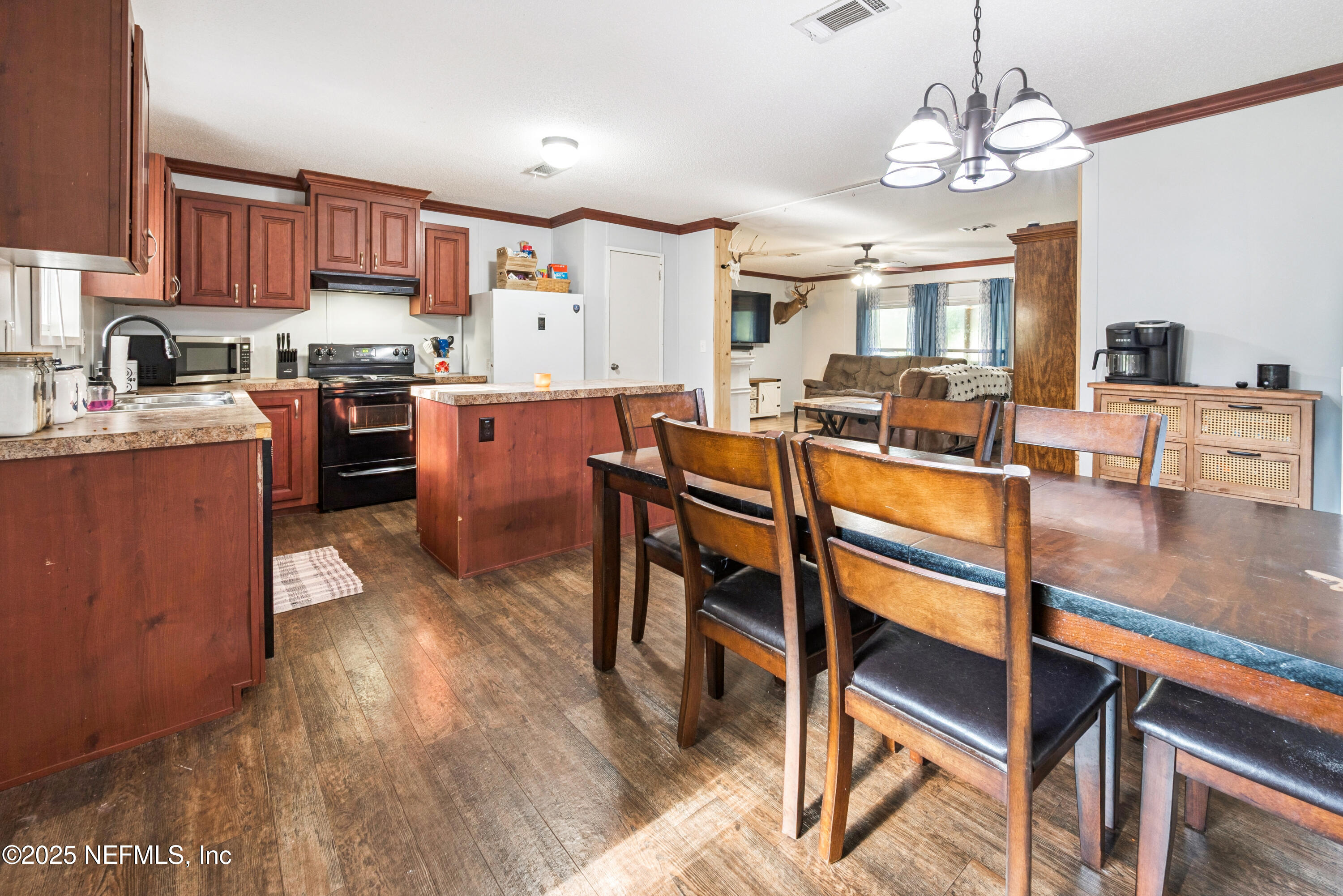 7236 Southeast 163rd Lane Lake Butler, FL 32054 - Photo 16 of 35 a kitchen with a dining table chairs stove and kitchen view