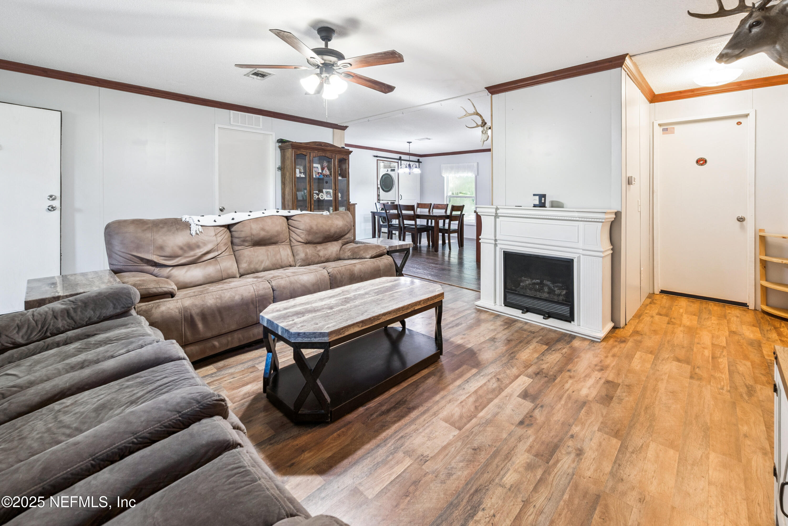 7236 Southeast 163rd Lane Lake Butler, FL 32054 - Photo 19 of 35 a living room with furniture a fireplace and a flat screen tv