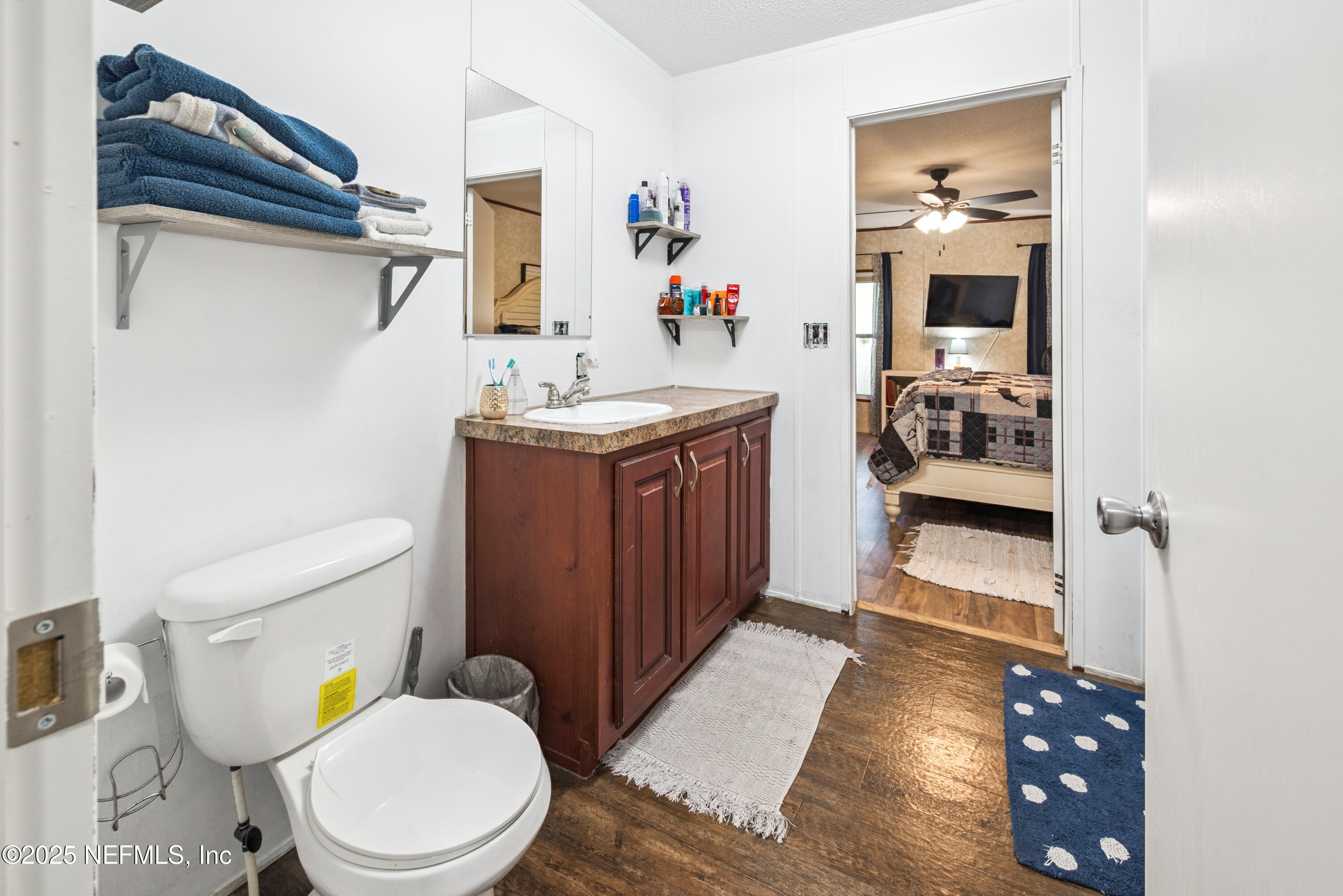 7236 Southeast 163rd Lane Lake Butler, FL 32054 - Photo 23 of 35 a bathroom with a toilet a sink and mirror