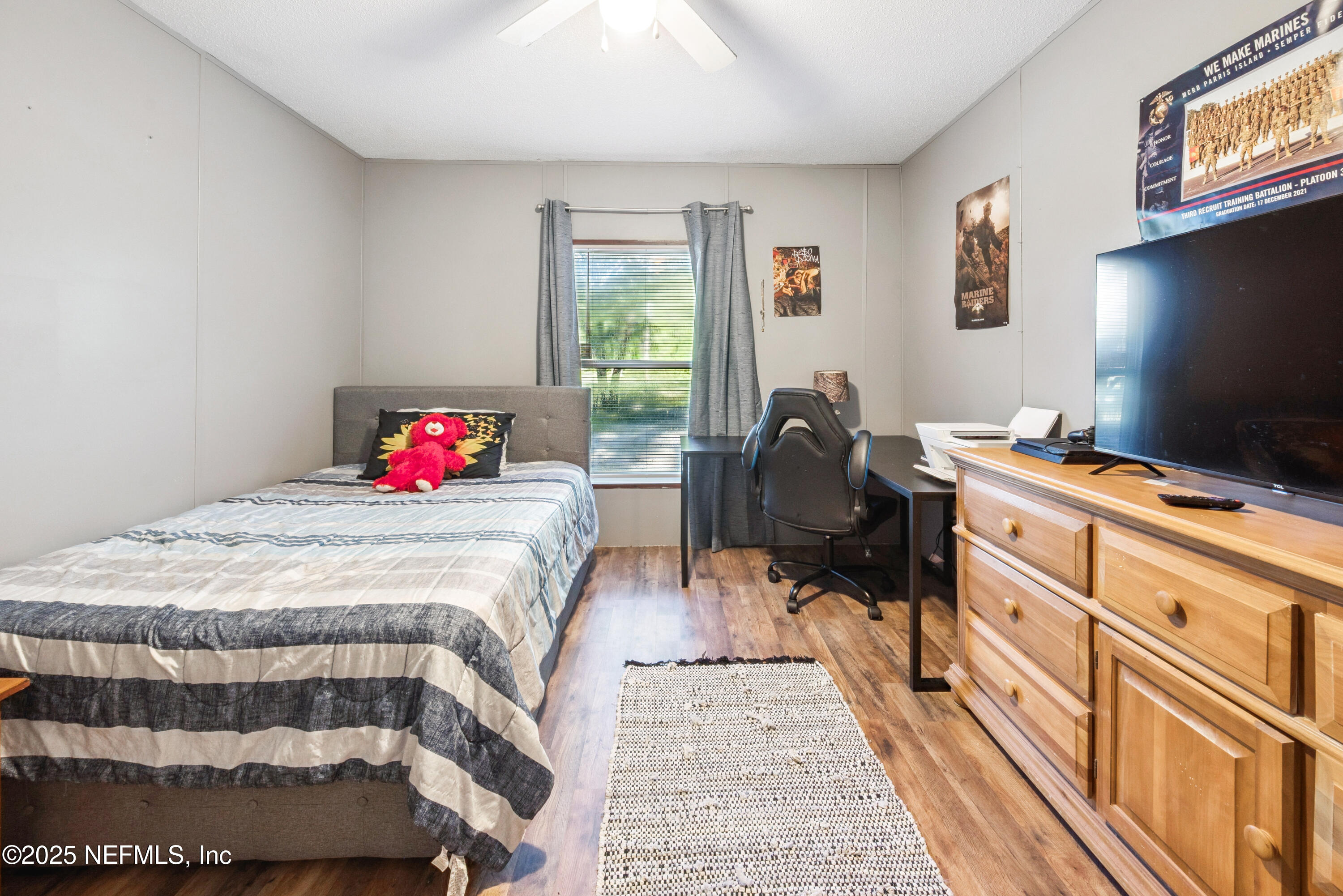 7236 Southeast 163rd Lane Lake Butler, FL 32054 - Photo 27 of 35 a bedroom with a bed and wooden floor