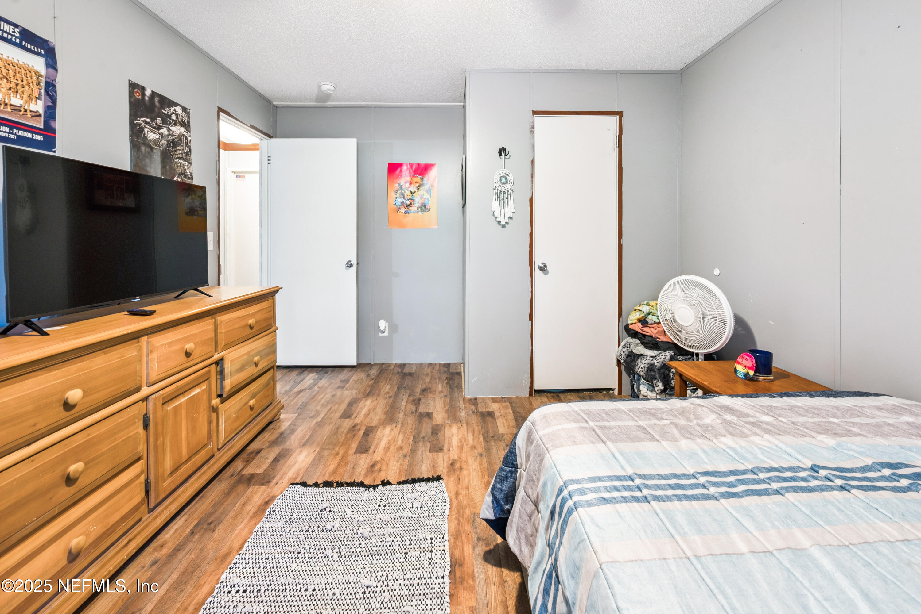 7236 Southeast 163rd Lane Lake Butler, FL 32054 - Photo 28 of 35 a bedroom with a bed and a flat screen tv