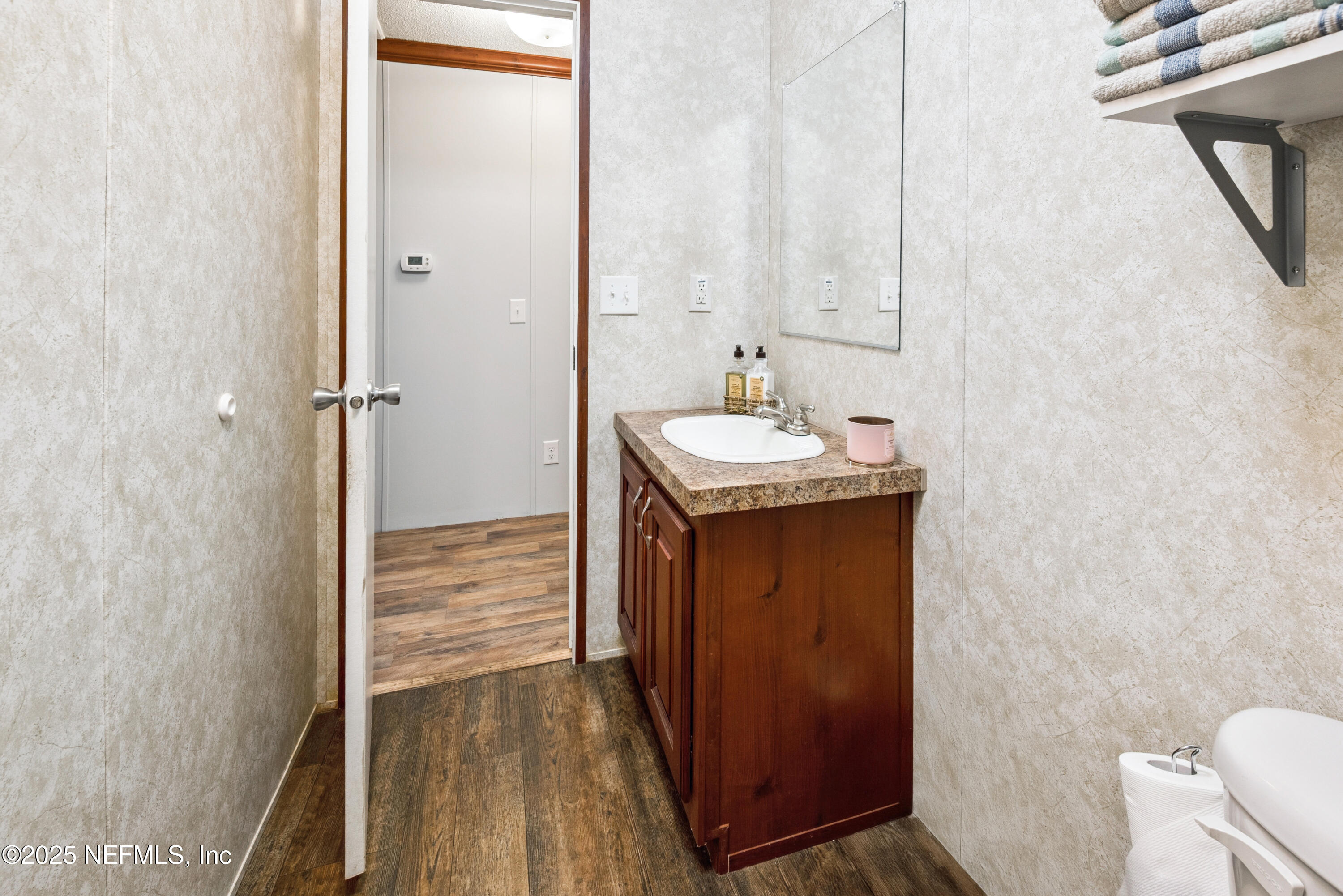 7236 Southeast 163rd Lane Lake Butler, FL 32054 - Photo 30 of 35 a bathroom with a sink and a mirror
